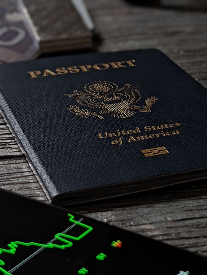awards-img Close-up of a United States passport on a rustic wooden table with a smartphone nearby.