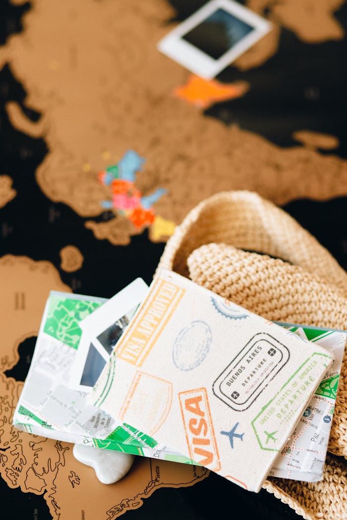 about-02 Travel essentials and accessories laid over a world map, highlighting wanderlust and adventure.